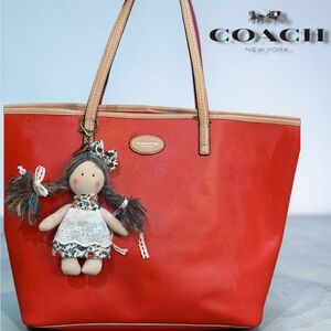 Coach Vermilion Metro leather tote bag accessorized with a handmade doll charm
